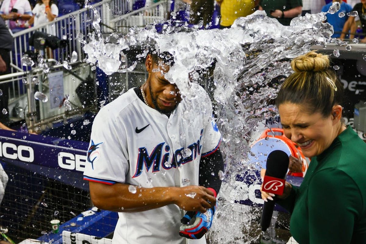 Jun 19, 2024; Miami, Florida, USA; Miami Marlins second baseman Otto Lopez (61) is doused with water after hitting a walk-off single against the St. Louis Cardinals during the ninth inning at loanDepot Park. Mandatory Credit: Sam Navarro-USA TODAY Sports