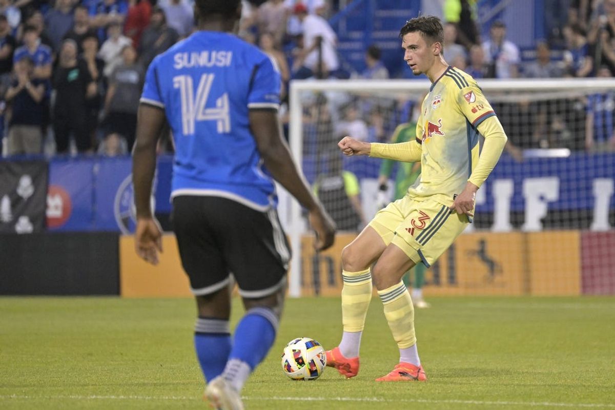 Jun 19, 2024; Montreal, Quebec, CAN; New York Red Bulls defender Noah Eile (3) plays a pass in front of CF Montreal forward Sunusi Ibrahim (14) during the second half at Stade Saputo. Mandatory Credit: Eric Bolte-USA TODAY Sports