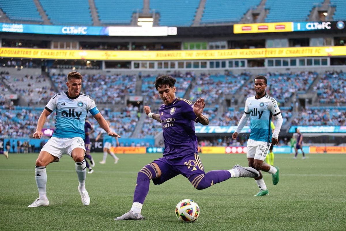Jun 19, 2024; Charlotte, North Carolina, USA; Orlando City forward Facundo Torres (10) passes into the box against Charlotte FC midfielder Ashley Westwood (8) during the first half  at Bank of America Stadium. Mandatory Credit: Scott Kinser-USA TODAY Sports