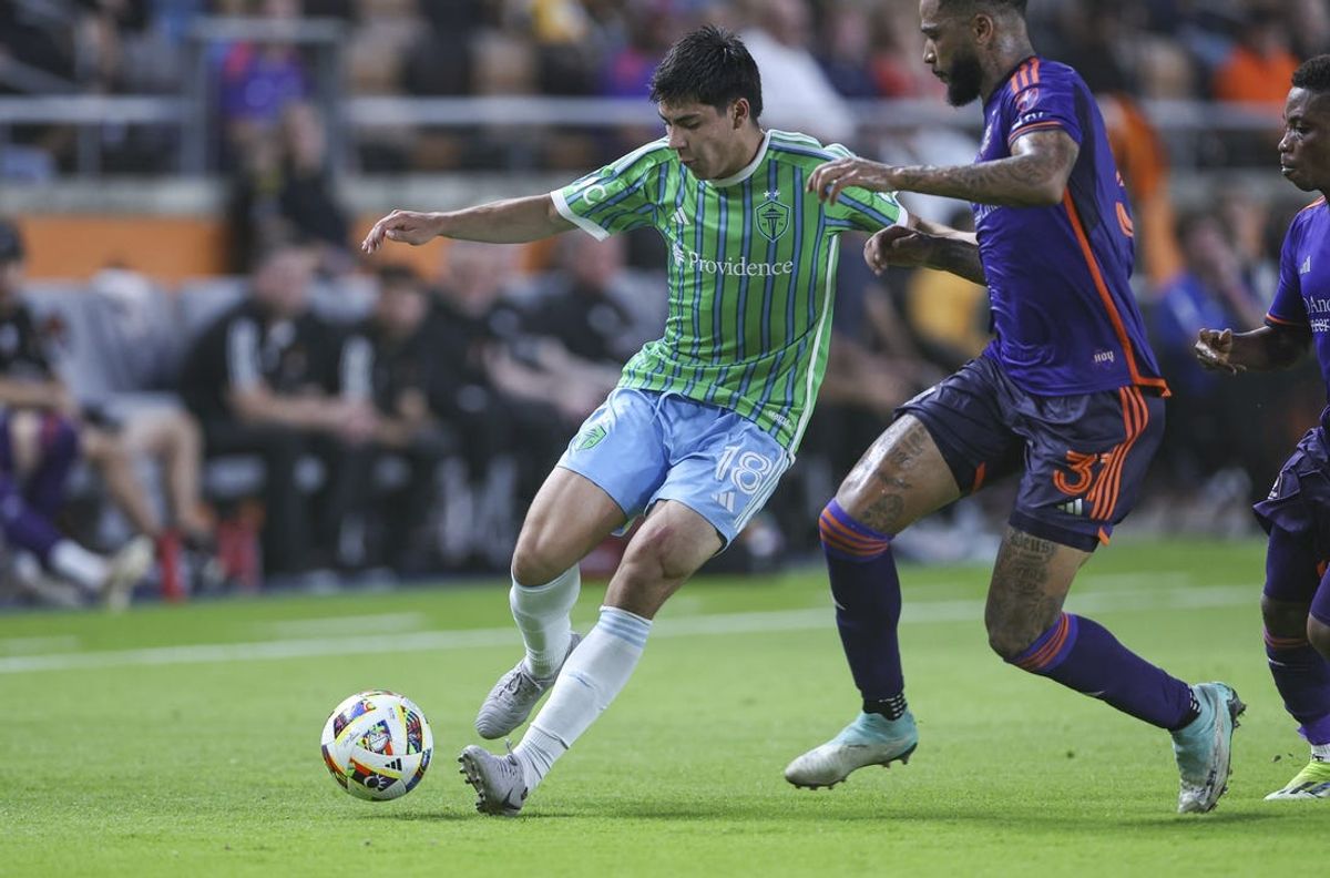 Jun 19, 2024; Houston, Texas, USA; Seattle Sounders FC midfielder Obed Vargas (18) controls the ball as Houston Dynamo FC defender Micael dos Santos (31) defends during the first half at Shell Energy Stadium. Mandatory Credit: Troy Taormina-USA TODAY Sports