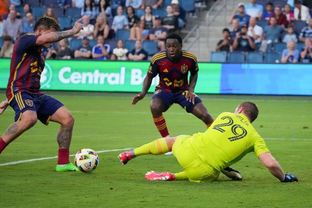 Jun 19, 2024; Kansas City, Kansas, USA; Real Salt Lake midfielder Diego Luna (8) kicks a shot on goal as Sporting Kansas City goalkeeper Tim Melia (29) defends during the first half at Children's Mercy Park. Mandatory Credit: Denny Medley-USA TODAY Sports