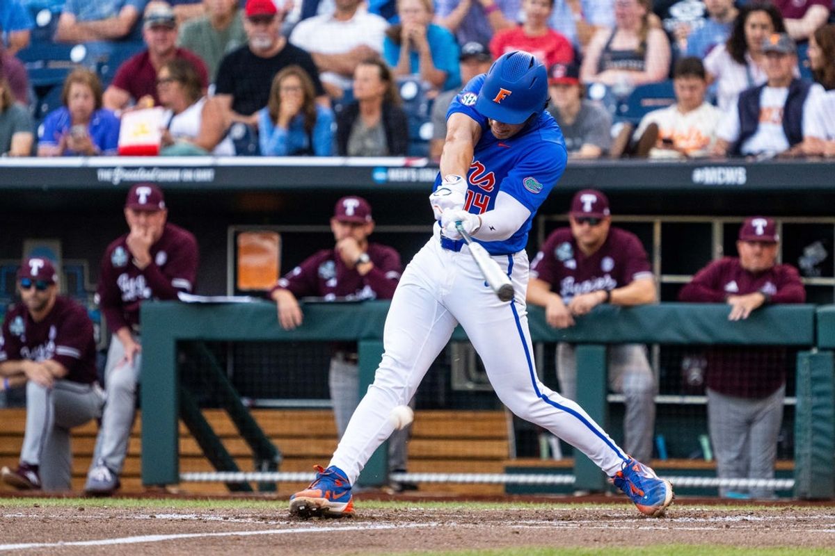 Jun 19, 2024; Omaha, NE, USA; Florida Gators first baseman Jac Caglianone (14) hits a single against the Texas A&M Aggies during the third inning at Charles Schwab Field Omaha. Mandatory Credit: Dylan Widger-Imagn Images