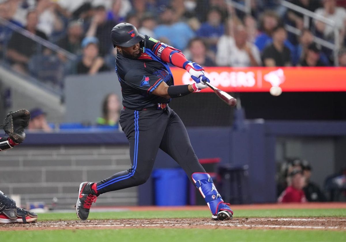 Jun 19, 2024; Toronto, Ontario, CAN; Toronto Blue Jays first base Vladimir Guerrero Jr. (27) hits a single against the Boston Red Sox during the seventh inning at Rogers Centre. Mandatory Credit: Nick Turchiaro-USA TODAY Sports