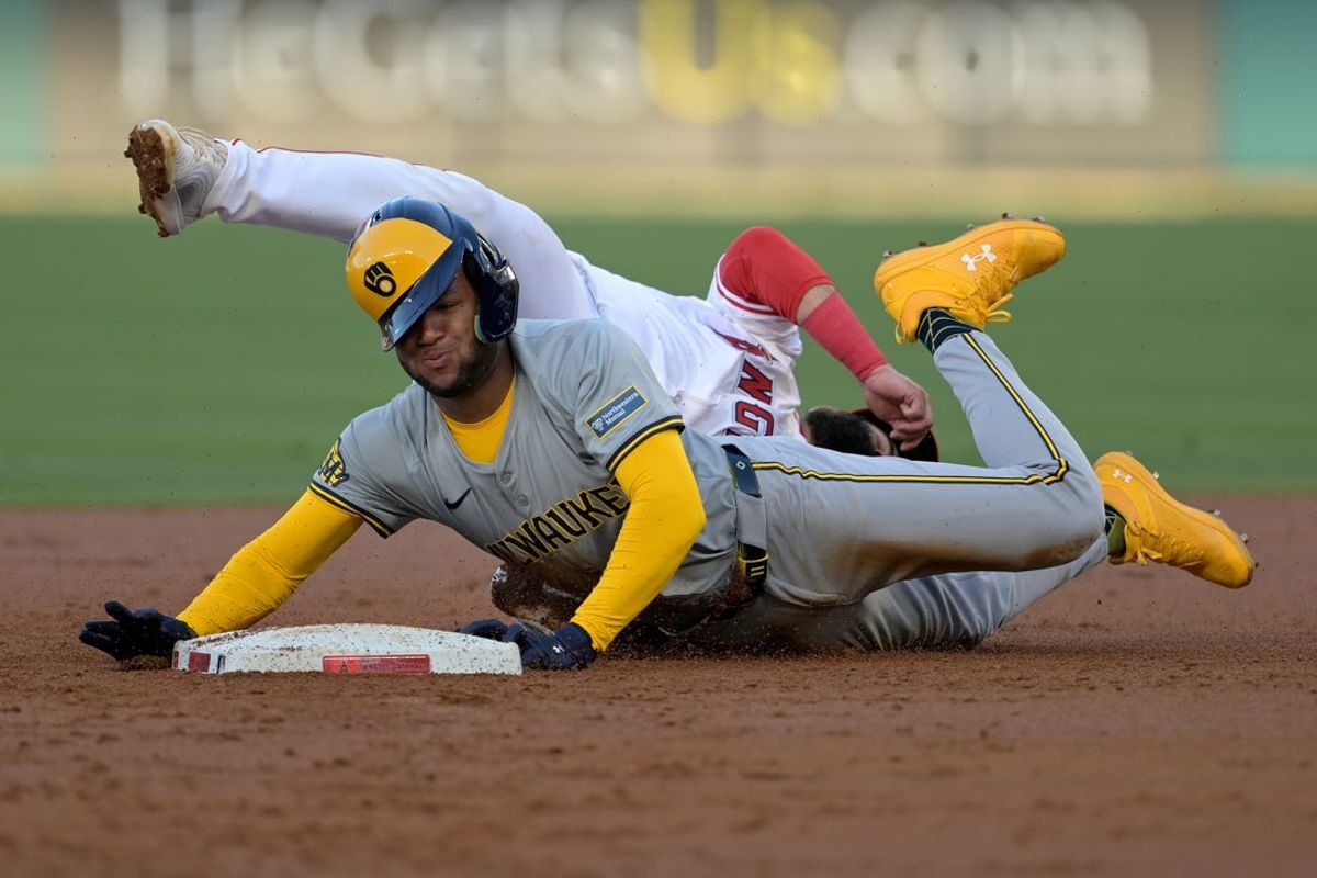 Jun 19, 2024; Anaheim, California, USA;  Los Angeles Angels second baseman Luis Guillorme (15) tags Milwaukee Brewers right fielder Jackson Chourio (11) out at second on an attempted stolen base in the second inning at Angel Stadium. Mandatory Credit: Jayne Kamin-Oncea-USA TODAY Sports