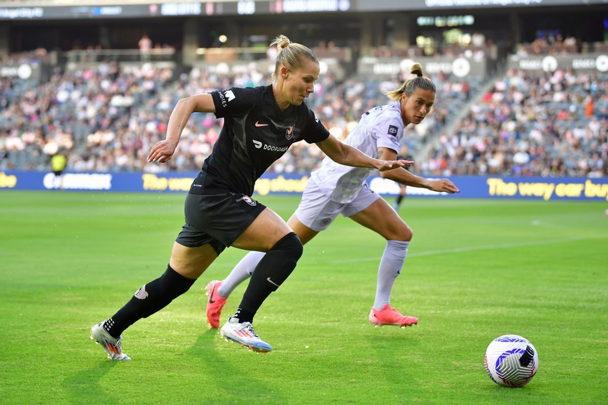 Jun 19, 2024; Los Angeles, California, USA; Angel City FC defender Merritt Mathias (12) and Racing Louisville FC midfielder Maria DiGrande (14) run for the ball in the first half at BMO Stadium. Mandatory Credit: Gary A. Vasquez-Imagn Images