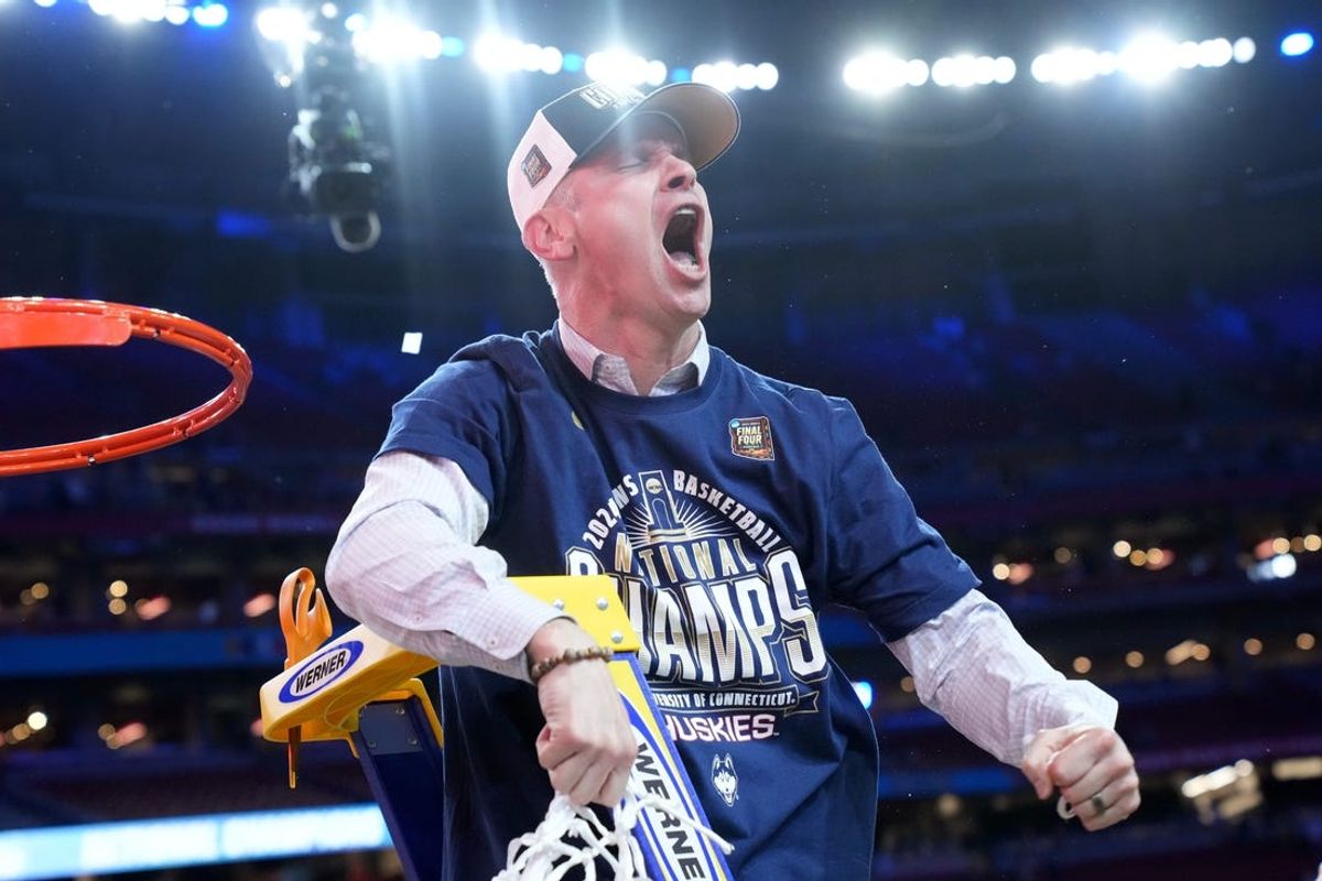 Connecticut Huskies head coach Dan Hurley cuts down the cut after defeating the Purdue Boilermakers in the national championship game of the Final Four of the 2024 NCAA Tournament at State Farm Stadium in Glendale on April 8, 2024.