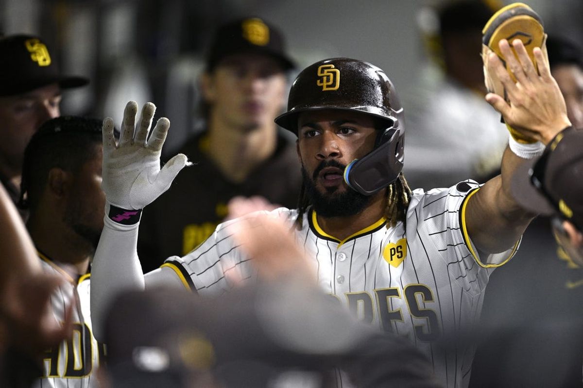 Jun 20, 2024; San Diego, California, USA; San Diego Padres right fielder Fernando Tatis Jr. (23) is congratulated in the dugout after scoring a run against the Milwaukee Brewers during the seventh inning at Petco Park. Mandatory Credit: Orlando Ramirez-USA TODAY Sports