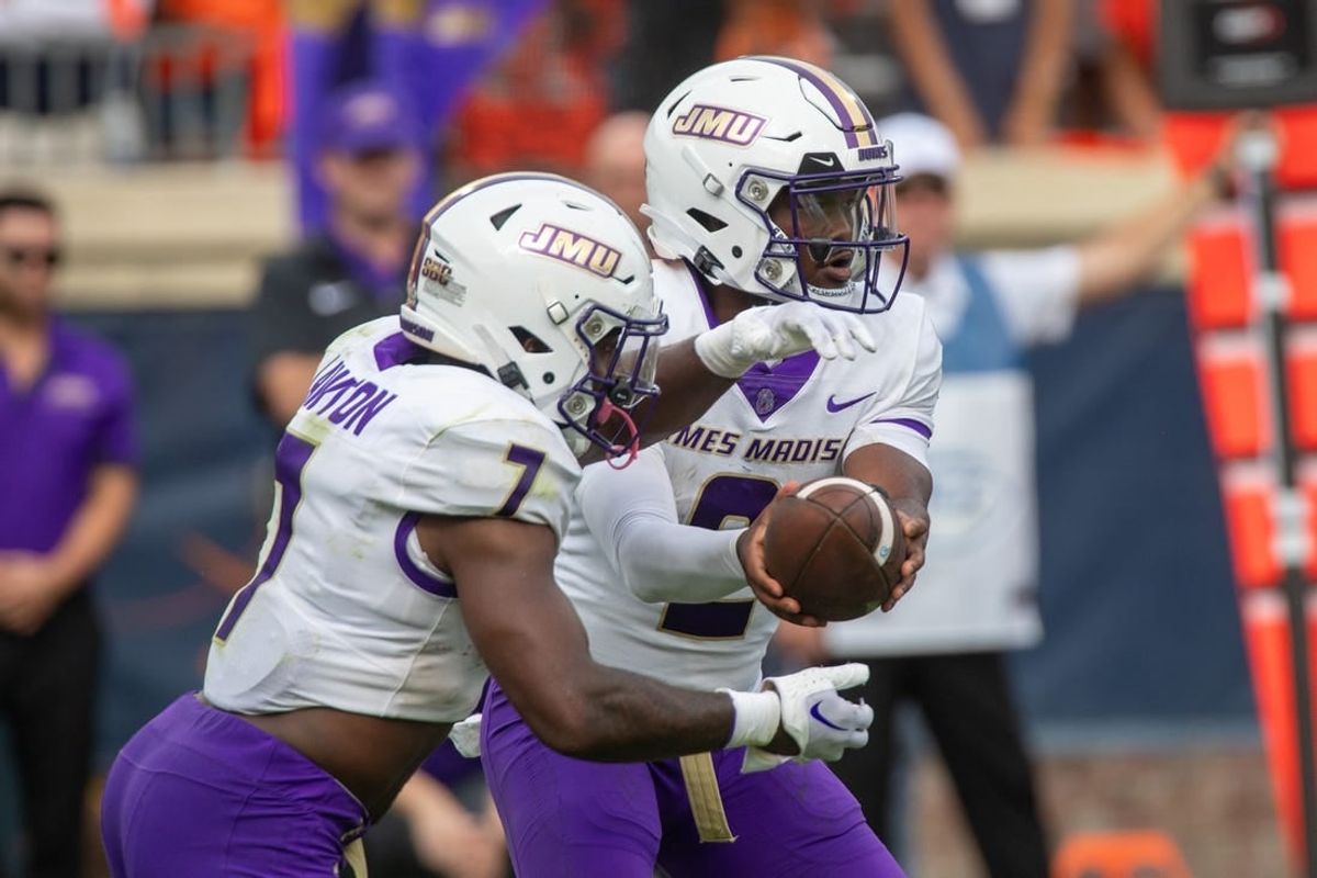 Sept 9, 2023; Charlottesville, Virginia, USA; James Madison Dukes quarterback Jordan McCloud (2) passes off the ball to James Madison Dukes running back Ty Son Lawton (7) to run a play during the second half at Scott Stadium.