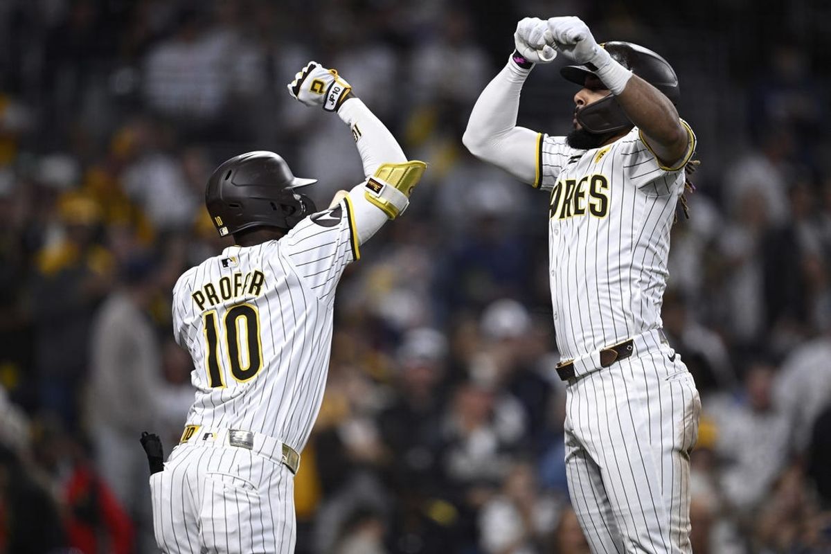 Jun 20, 2024; San Diego, California, USA; San Diego Padres right fielder Fernando Tatis Jr. (right) celebrates with designated hitter Jurickson Profar (10) after hitting a home run against the Milwaukee Brewers during the fifth inning at Petco Park. Mandatory Credit: Orlando Ramirez-USA TODAY Sports