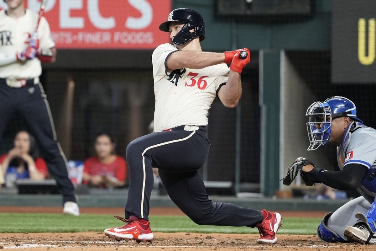 Jun 21, 2024; Arlington, Texas, USA; Texas Rangers left fielder Wyatt Langford (36) follows through on his RBI double against the Kansas City Royals during the fourth inning at Globe Life Field. Mandatory Credit: Jim Cowsert-USA TODAY Sports