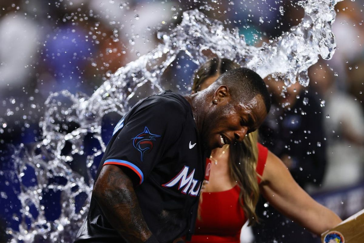 Jun 21, 2024; Miami, Florida, USA; Miami Marlins shortstop Tim Anderson (7) is doused with water after hitting a walk-off single against the Seattle Mariners during the tenth inning at loanDepot Park. Mandatory Credit: Sam Navarro-USA TODAY Sports