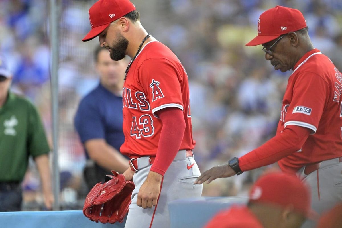 Jun 21, 2024; Los Angeles, California, USA;  Los Angeles Angels starting pitcher Patrick Sandoval (43) is followed by manager Ron Washington (37) as he leaves the game after an injury during the third inning against the Los Angeles Dodgers at Dodger Stadium. Mandatory Credit: Jayne Kamin-Oncea-USA TODAY Sports