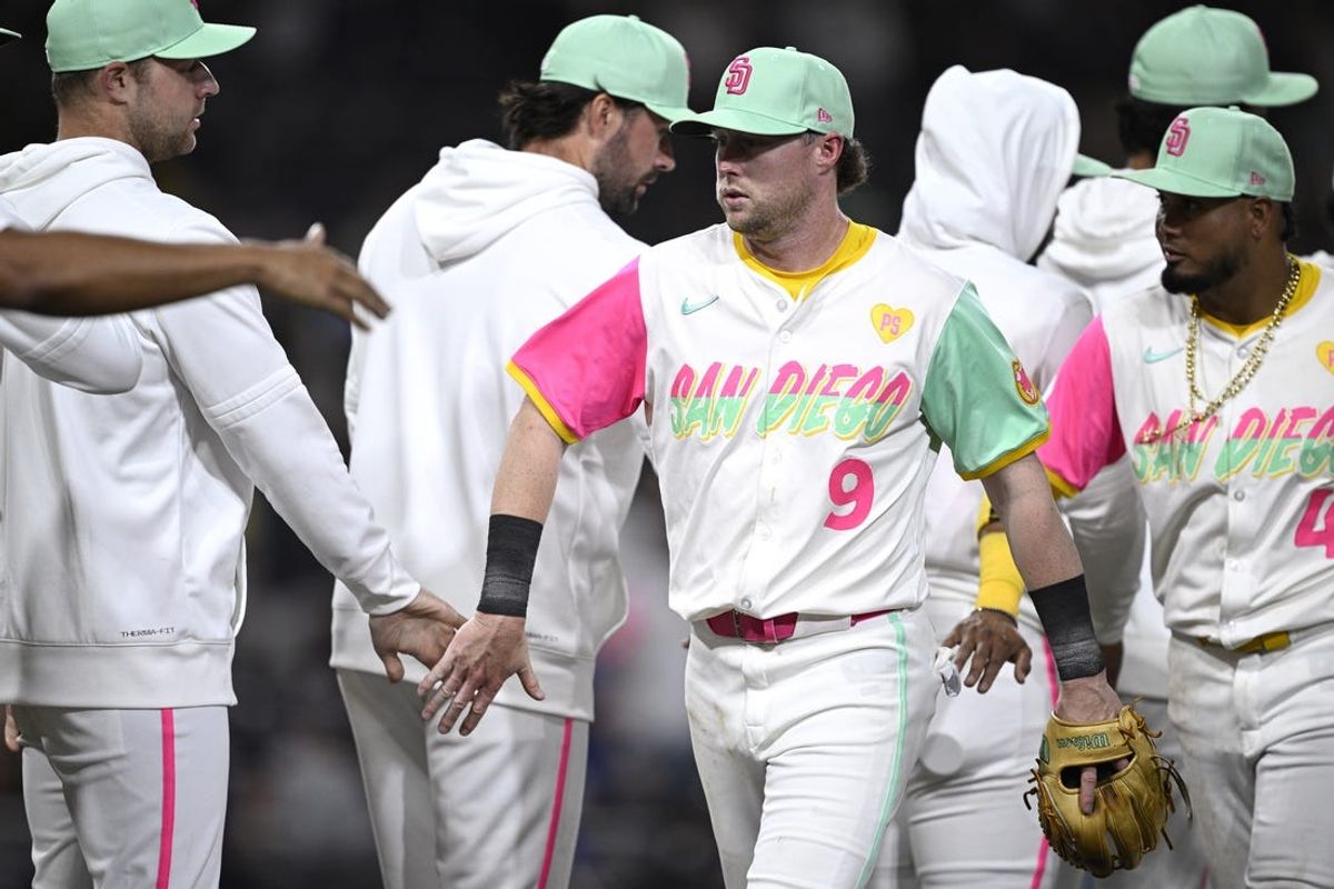 Jun 21, 2024; San Diego, California, USA; San Diego Padres second baseman Jake Cronenworth (9) celebrates on the field with teammates after defeating the Milwaukee Brewers at Petco Park. Mandatory Credit: Orlando Ramirez-USA TODAY Sports