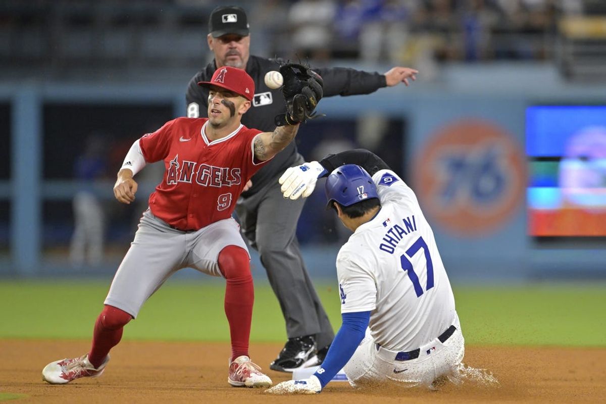 Jun 21, 2024; Los Angeles, California, USA;  Los Angeles Dodgers designated hitter Shohei Ohtani (17) is tagged out by Los Angeles Angels shortstop Zach Neto (9) on an attempted stolen base in the eighth inning at Dodger Stadium. Mandatory Credit: Jayne Kamin-Oncea-USA TODAY Sports