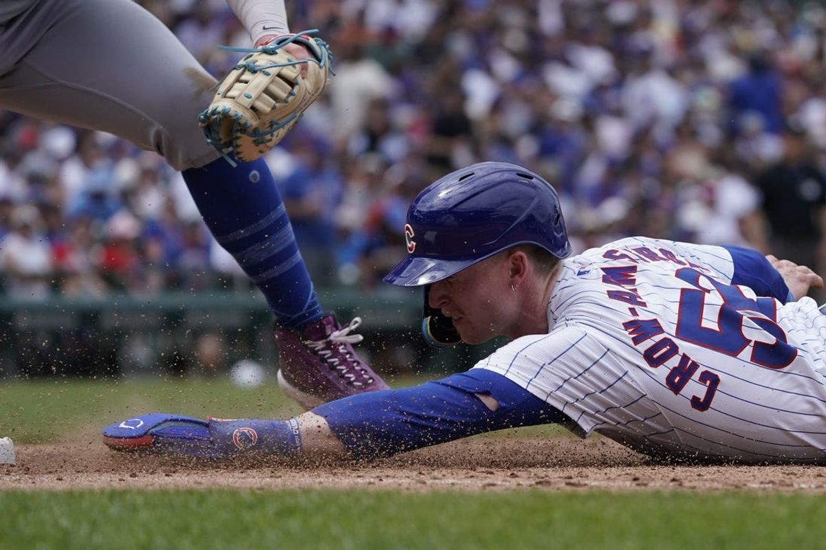 Jun 22, 2024; Chicago, Illinois, USA; Chicago Cubs outfielder Pete Crow-Armstrong (52) dives safely into first base as New York Mets first base Pete Alonso (20) makes a late tag during the sixth inning at Wrigley Field. Mandatory Credit: David Banks-USA TODAY Sports