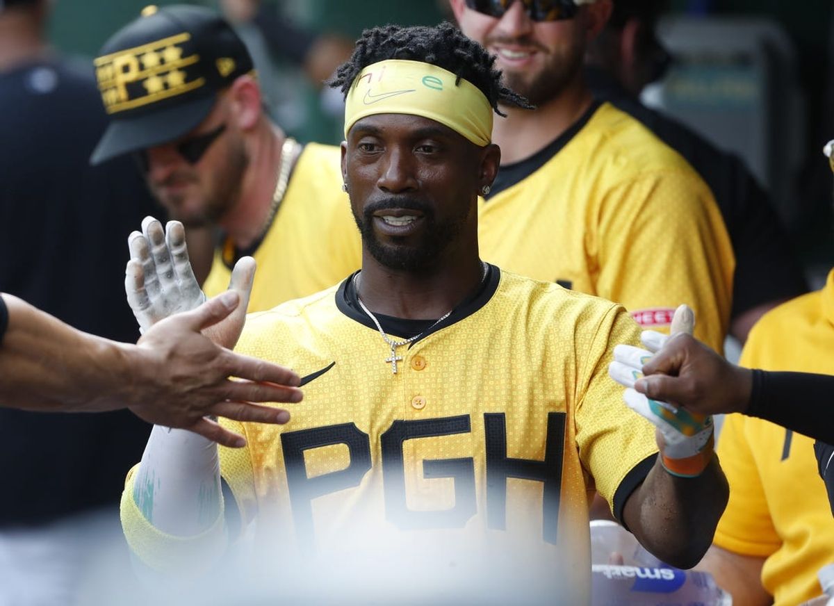 Jun 22, 2024; Pittsburgh, Pennsylvania, USA;  Pittsburgh Pirates designated hitter Andrew McCutchen (22) high-fives in the dugout after scoring a run against theTampa Bay Rays during the third inning at PNC Park. Mandatory Credit: Charles LeClaire-USA TODAY Sports