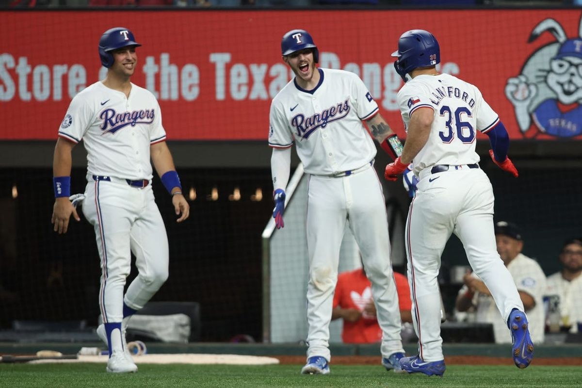 Jun 22, 2024; Arlington, Texas, USA; Texas Rangers left fielder Wyatt Langford (36) is congratulated by his teammates after hitting a grand slam home run in the eighth inning against the Kansas City Royals at Globe Life Field. Mandatory Credit: Tim Heitman-USA TODAY Sports
