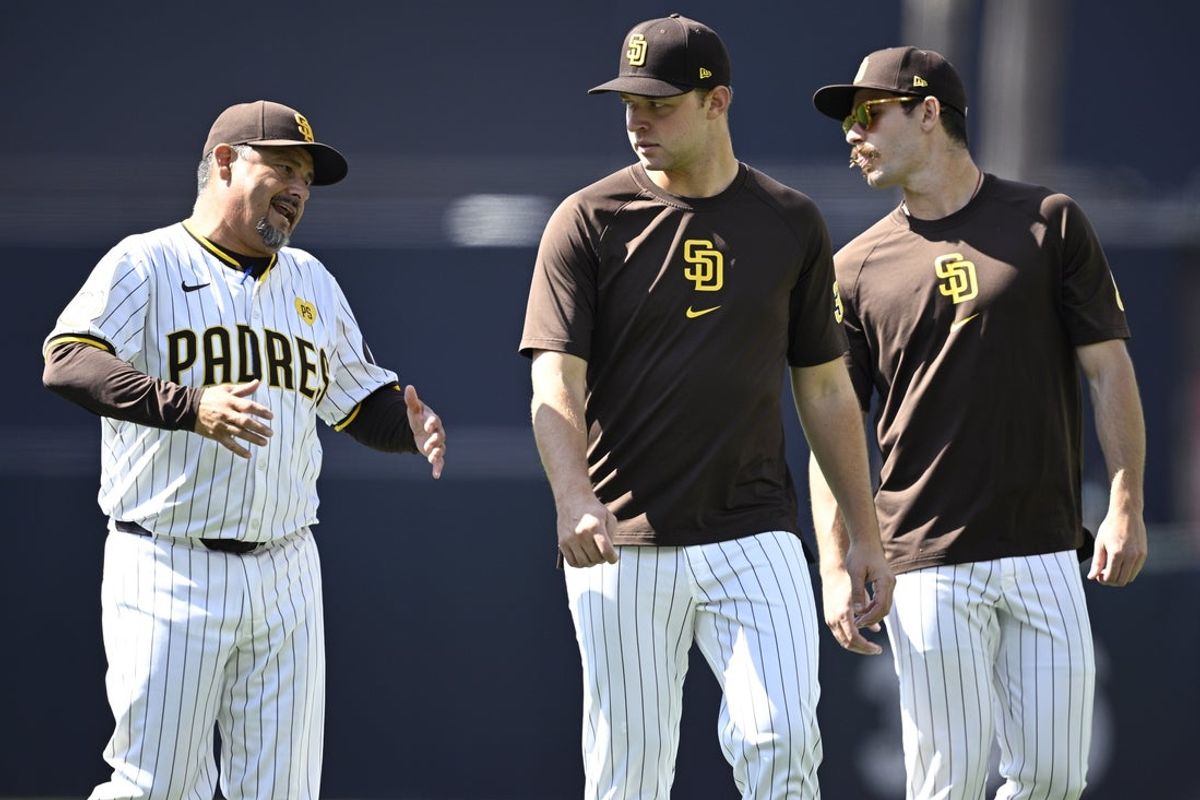 Jun 22, 2024; San Diego, California, USA; San Diego Padres pitching coach Ruben Niebla (left) talks to starting pitcher Michael King (center) and starting pitcher Dylan Cease (right) before the game against the Milwaukee Brewers at Petco Park. Mandatory Credit: Orlando Ramirez-Imagn Images