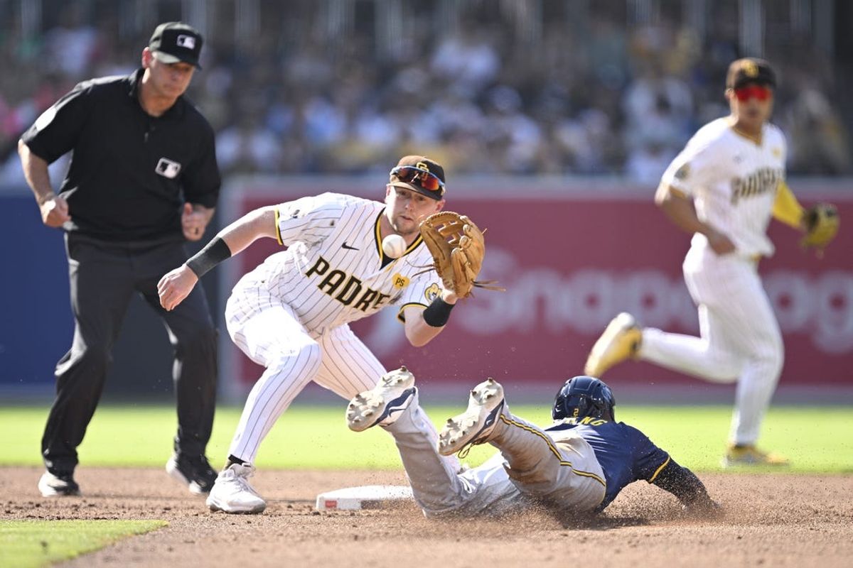 Jun 22, 2024; San Diego, California, USA; Milwaukee Brewers second baseman Brice Turang (2) is caught stealing second base by San Diego Padres second baseman Jake Cronenworth (9) during the third inning at Petco Park. Mandatory Credit: Orlando Ramirez-USA TODAY Sports