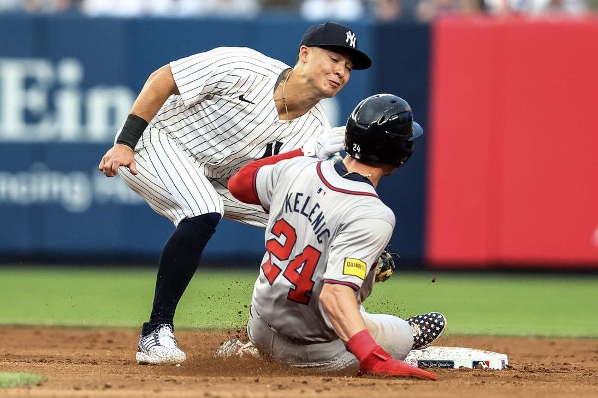 Jun 22, 2024; Bronx, New York, USA;  Atlanta Braves center fielder Jarred Kelenic (24) is tagged out while attempting to steal second base against New York Yankees shortstop Anthony Volpe (11) in the third inning at Yankee Stadium. Mandatory Credit: Wendell Cruz-USA TODAY Sports