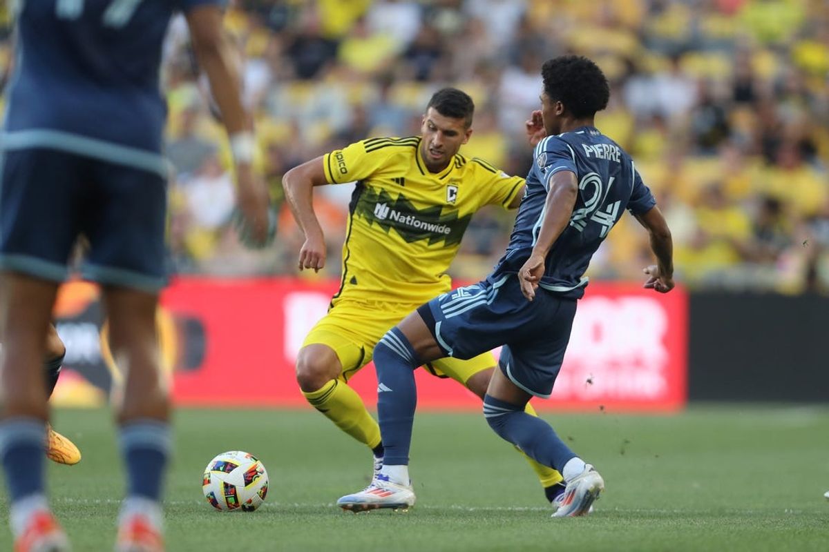 Jun 22, 2024; Columbus, Ohio, USA; Sporting Kansas City defender Kayden Pierre (24) and Columbus Crew defender Yevhen Cheberko (21) battle for the ball in the first half at Lower.com Field. Mandatory Credit: Joseph Maiorana-USA TODAY Sports