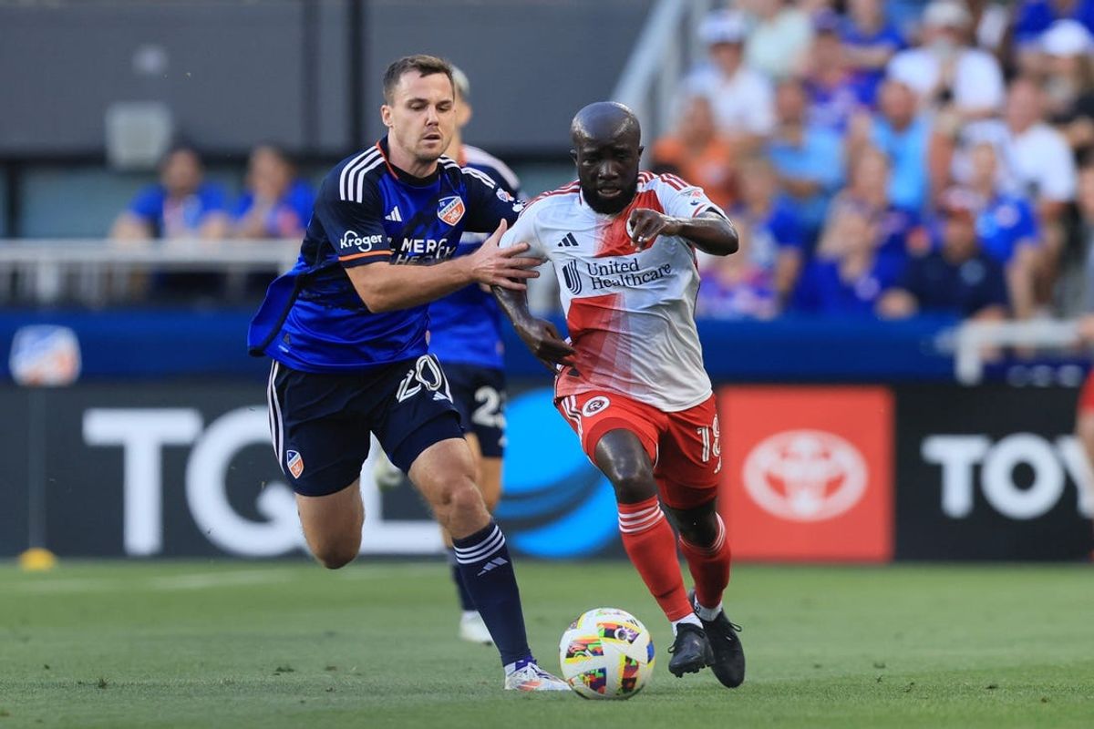 Jun 22, 2024; Cincinnati, Ohio, USA; New England Revolution midfielder Emmanuel Boateng (18) and FC Cincinnati midfielder Pavel Bucha (20) battle for the ball in the first half at TQL Stadium. Mandatory Credit: Katie Stratman-USA TODAY Sports