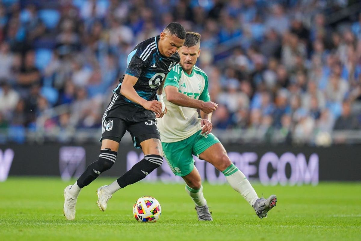 Jun 22, 2024; Saint Paul, Minnesota, USA;  Minnesota United midfielder Kervin Arriaga (33) controls the ball against Austin FC forward Diego Rubio (14) in the first half at Allianz Field. Mandatory Credit: Brad Rempel-USA TODAY Sports
