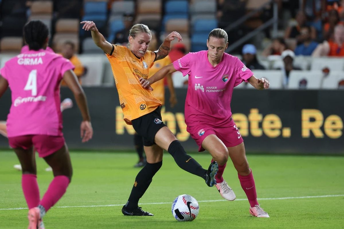 Jun 22, 2024; Houston, Texas, USA; Houston Dash midfielder Sophie Schmidt (13) and San Diego Wave FC midfielder Emily van Egmond (5) battle for the ball in the second half at Shell Energy Stadium. Mandatory Credit: Thomas Shea-USA TODAY Sports