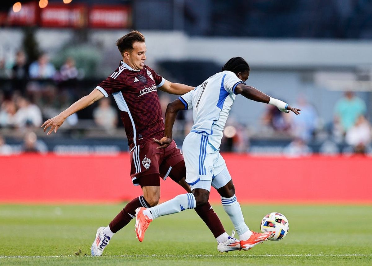 Jun 22, 2024; Commerce City, Colorado, USA; Colorado Rapids midfielder Cole Bassett (23) battles for the ball against CF Montreal forward Kwadwo Opoku (7) during the first half at Dick's Sporting Goods Park. Mandatory Credit: Isaiah J. Downing-USA TODAY Sports