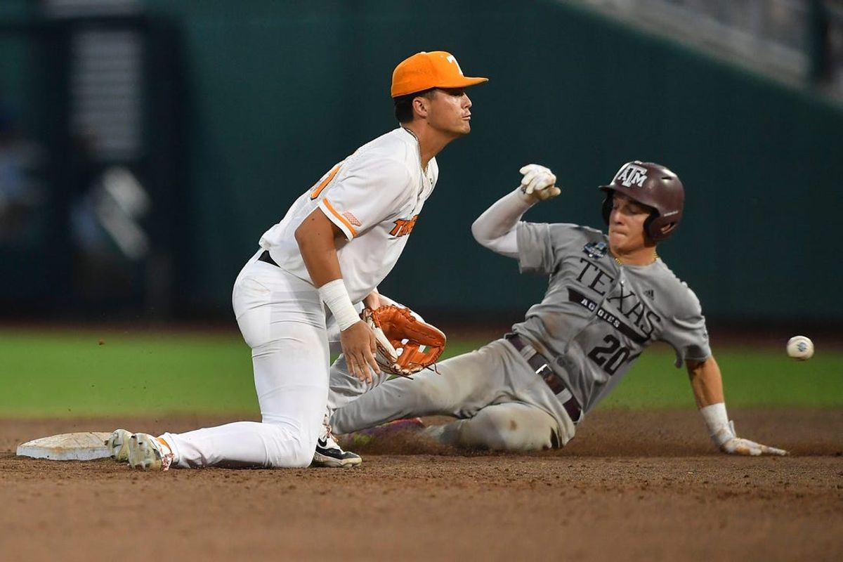 Texas A&M's Jackson Appel (20) slides safely into second base during a NCAA College World Series game between Tennessee and Texas A&M at Charles Schwab Field in Omaha, Neb., on Saturday, June 22, 2024.