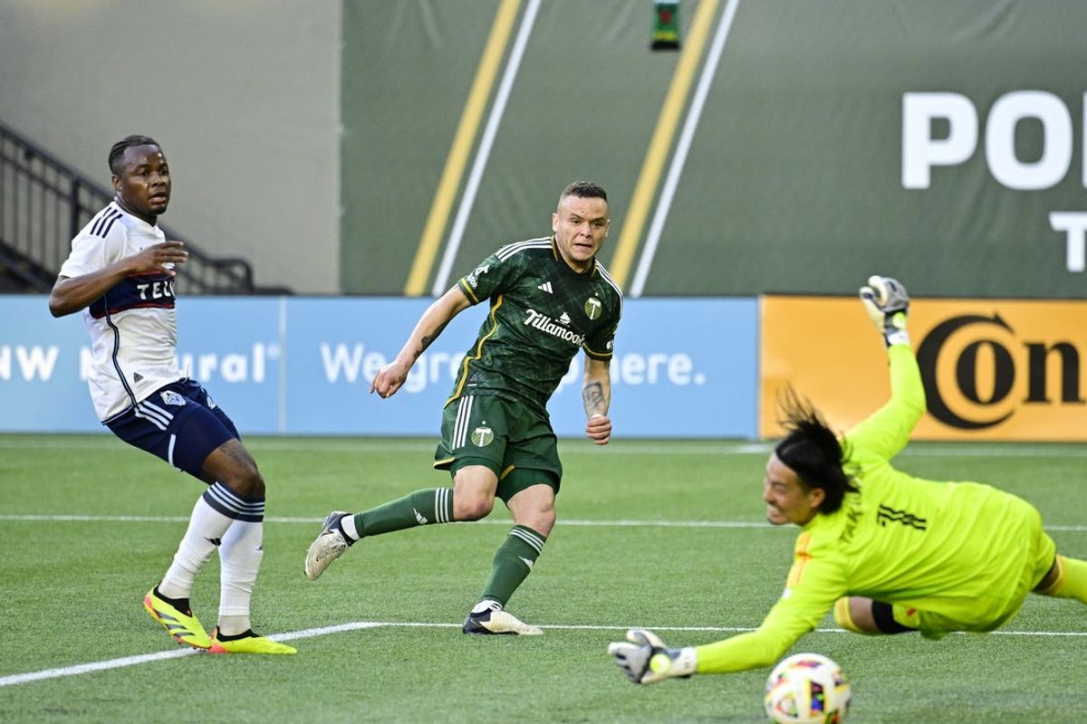 Jun 22, 2024; Portland, Oregon, USA; Portland Timbers forward Jonathan Rodriguez (14) scores a goal against Vancouver Whitecaps FC goalkeeper Yohei Takaoka (1) during the first half at Providence Park. Mandatory Credit: Troy Wayrynen-USA TODAY Sports