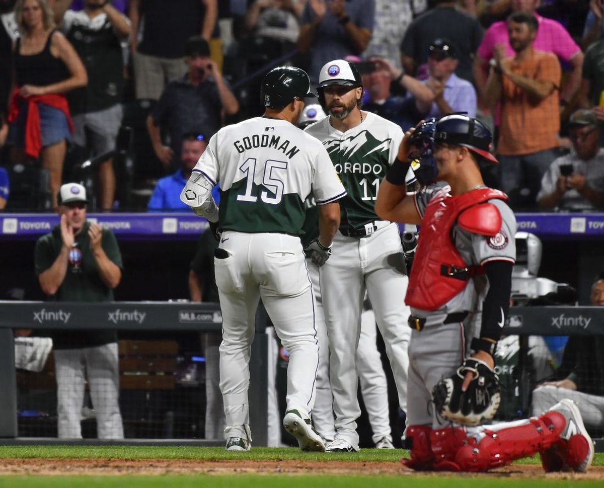Jun 22, 2024; Denver, Colorado, USA; Colorado Rockies designated hitter Hunter Goodman (15) celebrates with outfielder Jake Cave (11) after hitting a home run against the Washington Nationals in the seventh inning at Coors Field. Mandatory Credit: John Leyba-USA TODAY Sports