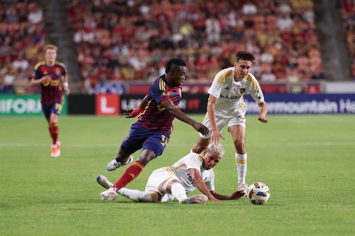 Jun 22, 2024; Sandy, Utah, USA; Real Salt Lake midfielder Andres Gomez (11) and LA Galaxy midfielder Edwin Cerrillo (20) battle for the ball in the second half at America First Field. Mandatory Credit: Rob Gray-USA TODAY Sports