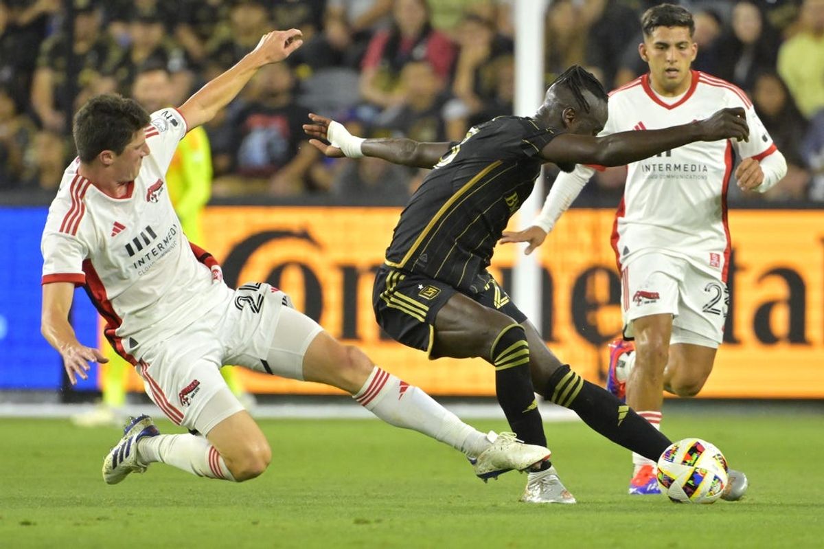 Jun 22, 2024; Los Angeles, California, USA;  LAFC forward Kei Kamara (23) and San Jose Earthquakes defender Daniel Munie (24) battle for the ball in the second half at BMO Stadium. Mandatory Credit: Jayne Kamin-Oncea-USA TODAY Sports
