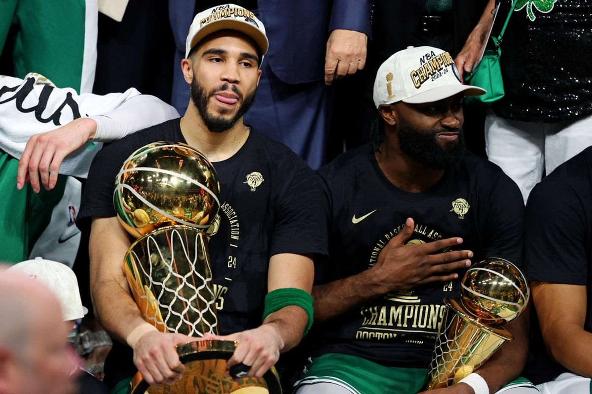 Jun 17, 2024; Boston, Massachusetts, USA; Boston Celtics forward Jayson Tatum (0) and guard Jaylen Brown (7) celebrates with the Larry O’Brian Trophy after beating the Dallas Mavericks in game five of the 2024 NBA Finals to win the NBA Championship at TD Garden. Mandatory Credit: Peter Casey-Imagn Images