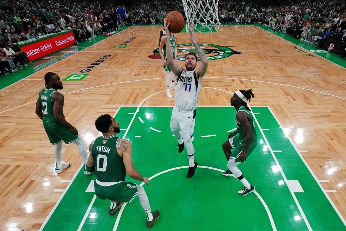 Jun 17, 2024; Boston, Massachusetts, USA; Dallas Mavericks guard Luka Doncic (77) shoots the ball against Boston Celtics forward Jayson Tatum (0) in game five of the 2024 NBA Finals at TD Garden. Mandatory Credit: Peter Casey-USA TODAY Sports