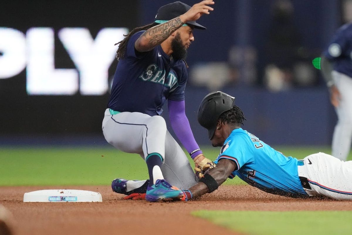 Jun 23, 2024; Miami, Florida, USA;  Miami Marlins designated hitter Jazz Chisholm Jr. (2) collides with Seattle Mariners shortstop J.P. Crawford (3) on a double in the first inning at loanDepot Park. Mandatory Credit: Jim Rassol-USA TODAY Sports