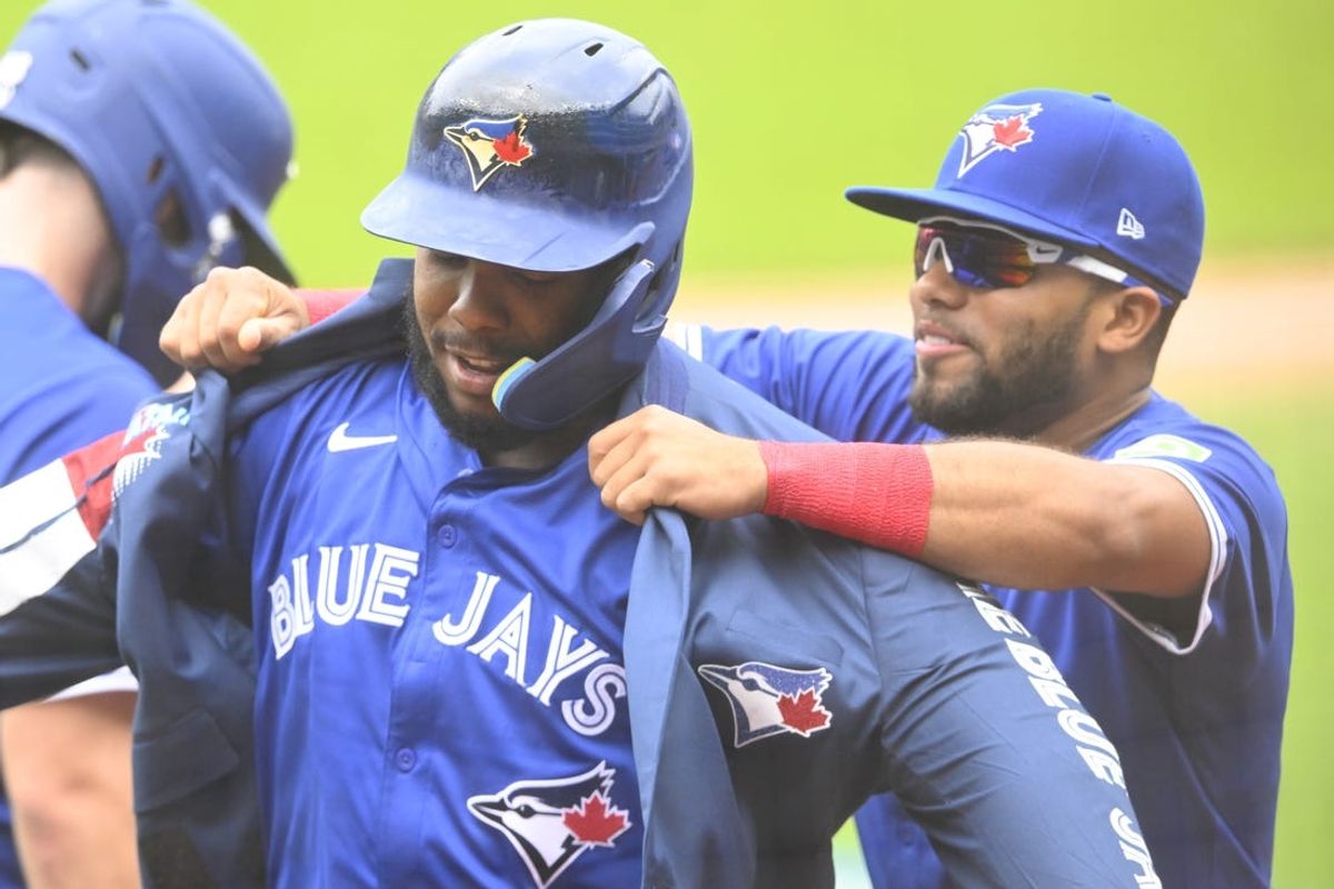 Jun 23, 2024; Cleveland, Ohio, USA; Toronto Blue Jays first baseman Vladimir Guerrero Jr. (27) celebrates his two-run home run with outfielder Steward Berroa (37) in the first inning against the Cleveland Guardians at Progressive Field. Mandatory Credit: David Richard-USA TODAY Sports
