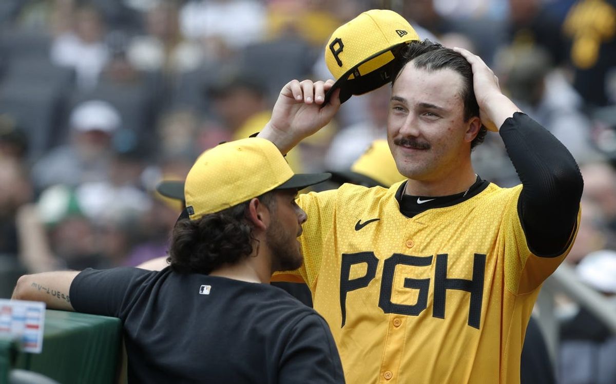 Jun 23, 2024; Pittsburgh, Pennsylvania, USA;  Pittsburgh Pirates starting pitcher Paul Skenes (right) reacts as he talks with pitcher Jared Jones (left) after the seventh inning against the Tampa Bay Rays at PNC Park. Mandatory Credit: Charles LeClaire-USA TODAY Sports