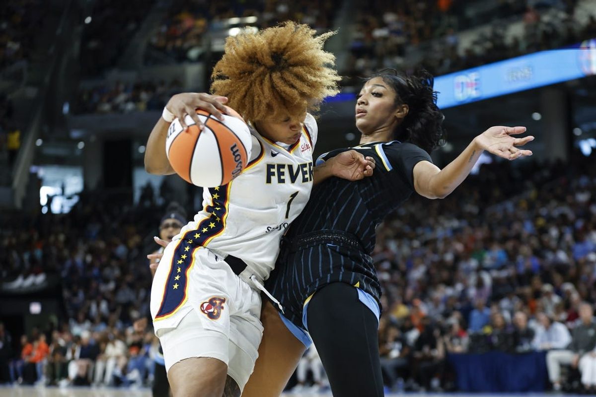 Jun 23, 2024; Chicago, Illinois, USA; Indiana Fever forward NaLyssa Smith (1) drives to the basket against Chicago Sky forward Angel Reese (5) during the first half at Wintrust Arena. Mandatory Credit: Kamil Krzaczynski-USA TODAY Sports