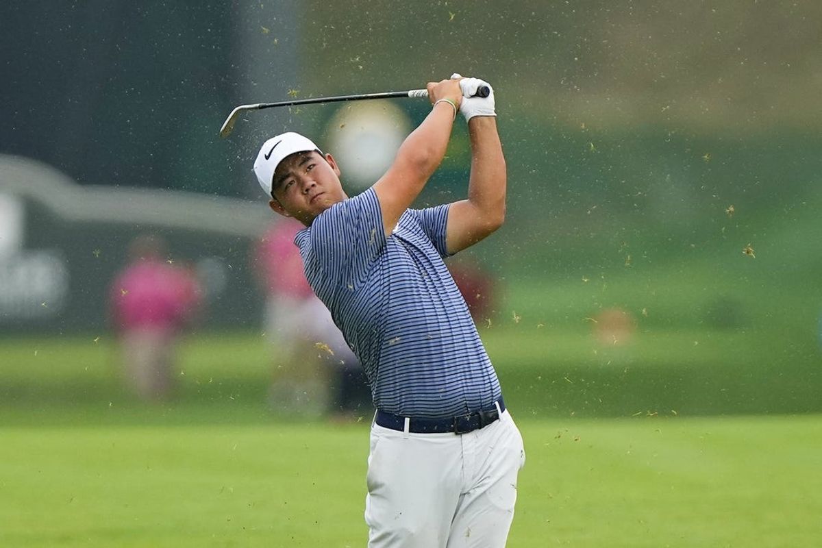 Jun 23, 2024; Cromwell, Connecticut, USA; Tom Kim hits the ball in the fairway of the eighteenth hole during the playoff round of the Travelers Championship golf tournament at TPC River Highlands. Mandatory Credit: Gregory Fisher-USA TODAY Sports