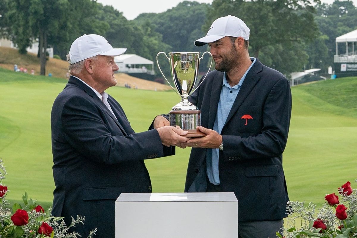 Jun 23, 2024; Cromwell, Connecticut, USA; Scottie Scheffler is presented with the Travelers Championship Trophy after winning the Travelers Championship golf tournament at TPC River Highlands. Mandatory Credit: Gregory Fisher-Imagn Images
