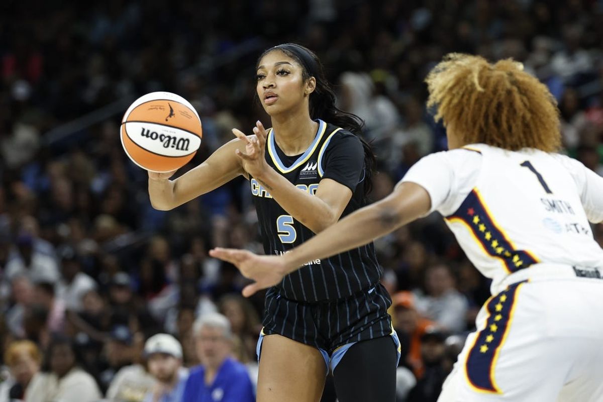 Jun 23, 2024; Chicago, Illinois, USA; Chicago Sky forward Angel Reese (5) passes the ball against Indiana Fever forward NaLyssa Smith (1) during the second half of a basketball game at Wintrust Arena. Mandatory Credit: Kamil Krzaczynski-USA TODAY Sports