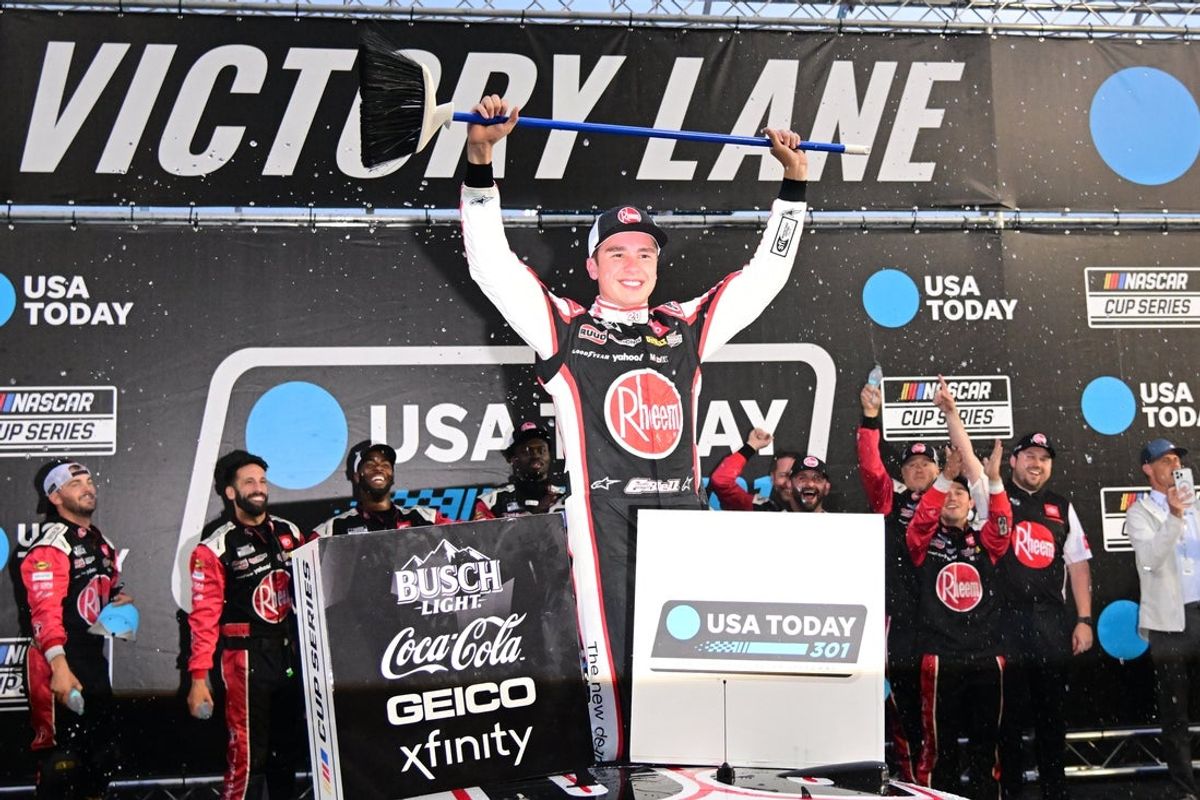 Jun 23, 2024; Loudon, New Hampshire, USA; NASCAR Cup Series driver Christopher Bell (20) celebrates winning the USA TODAY 301 and sweeping the weekend at New Hampshire Motor Speedway. Mandatory Credit: Eric Canha-Imagn Images
