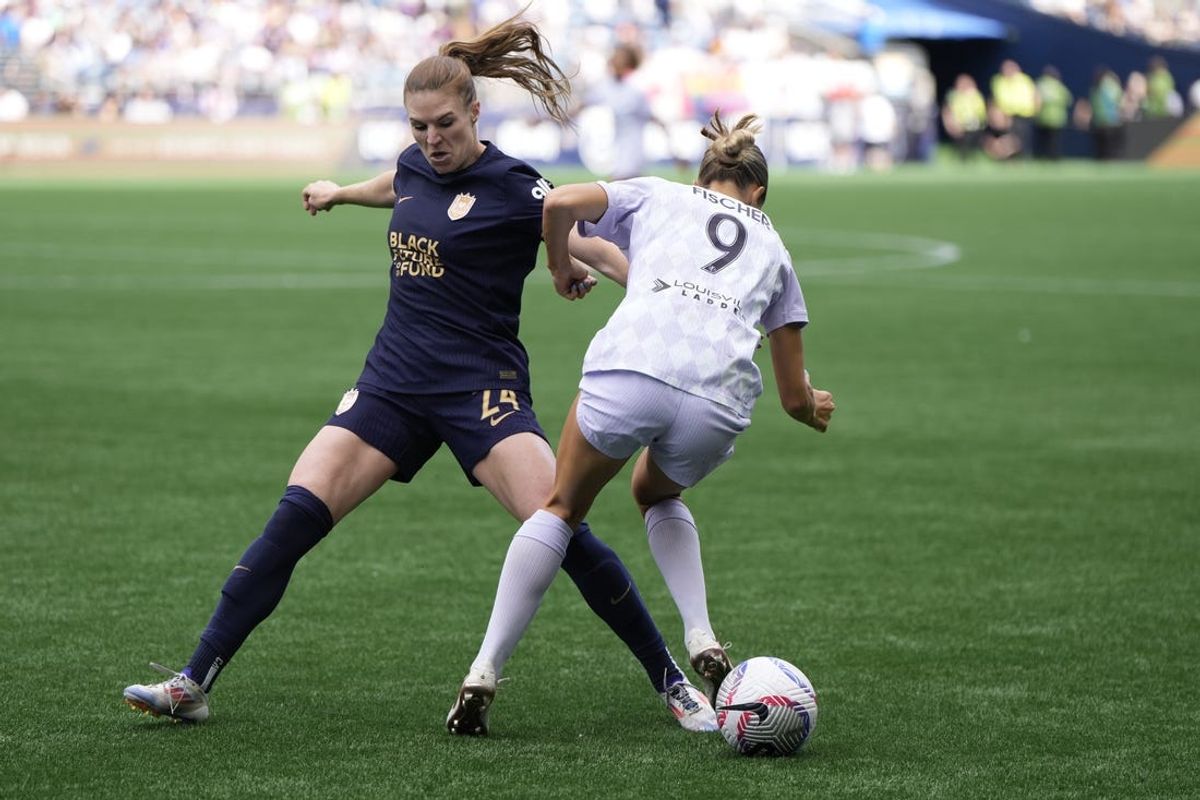 Jun 23, 2024; Seattle, Washington, USA; Seattle Reign FC forward Veronica Latsko (24) battles Racing Louisville FC midfielder Kayla Fischer (9) for the ball in the second half  at Lumen Field. Mandatory Credit: Stephen Brashear-USA TODAY Sports