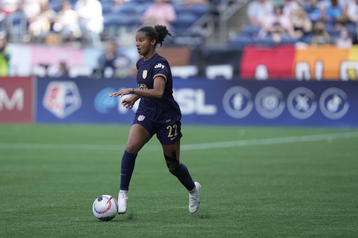 Jun 23, 2024; Seattle, Washington, USA; Seattle Reign FC defender Ryanne Brown (22) dribbles the ball in the match against Racing Louisville FC at Lumen Field. Mandatory Credit: Stephen Brashear-USA TODAY Sports