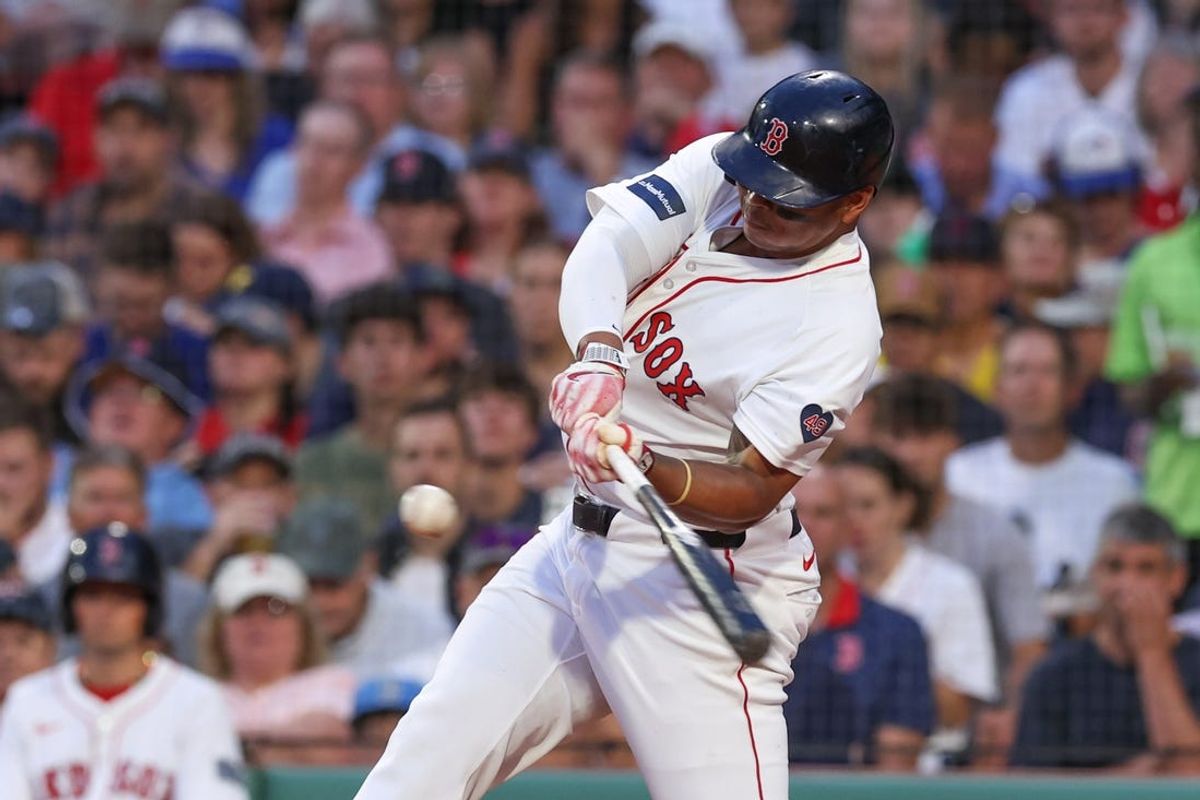 Jun 24, 2024; Boston, Massachusetts, USA; Boston Red Sox third baseman Rafael Devers (11) hits a two run home run during the fourth inning against the Toronto Blue Jays at Fenway Park. Mandatory Credit: Paul Rutherford-USA TODAY Sports