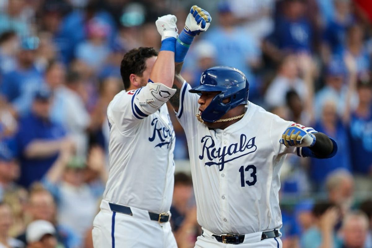 Jun 24, 2024; Kansas City, Missouri, USA; Kansas City Royals catcher Salvador Perez (13) slaps arms with Kansas City Royals first base Vinnie Pasquantino (9) after hitting a home run during the fourth inning against the Miami Marlins at Kauffman Stadium. Mandatory Credit: William Purnell-USA TODAY Sports