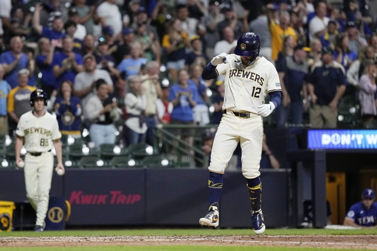 Jun 24, 2024; Milwaukee, Wisconsin, USA;  Milwaukee Brewers first baseman Rhys Hoskins (12) steps on home plate after hitting a grand slam home run during the sixth inning against the Texas Rangers at American Family Field. Mandatory Credit: Jeff Hanisch-USA TODAY Sports