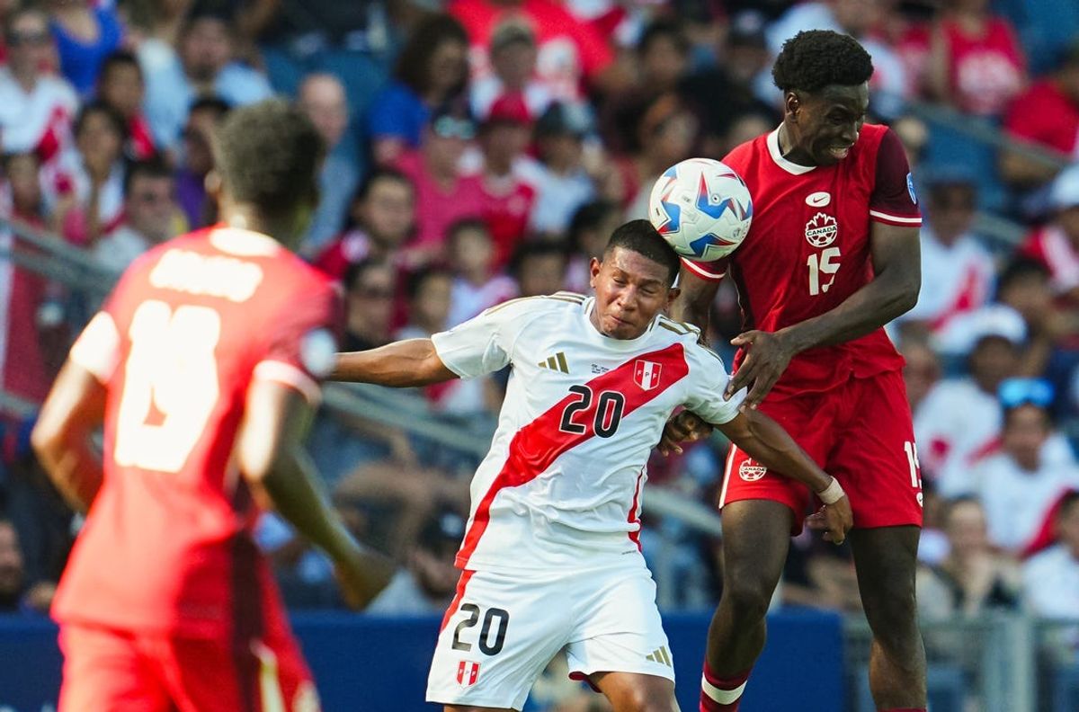 Jun 25, 2024; Kansas City, MO, USA; Peru forward Edison Flores (20) heads the ball against Canada defender Alphonso Davies (19) during the first half of a Copa America match at Children's Mercy Park. Mandatory Credit: Jay Biggerstaff-USA TODAY Sports